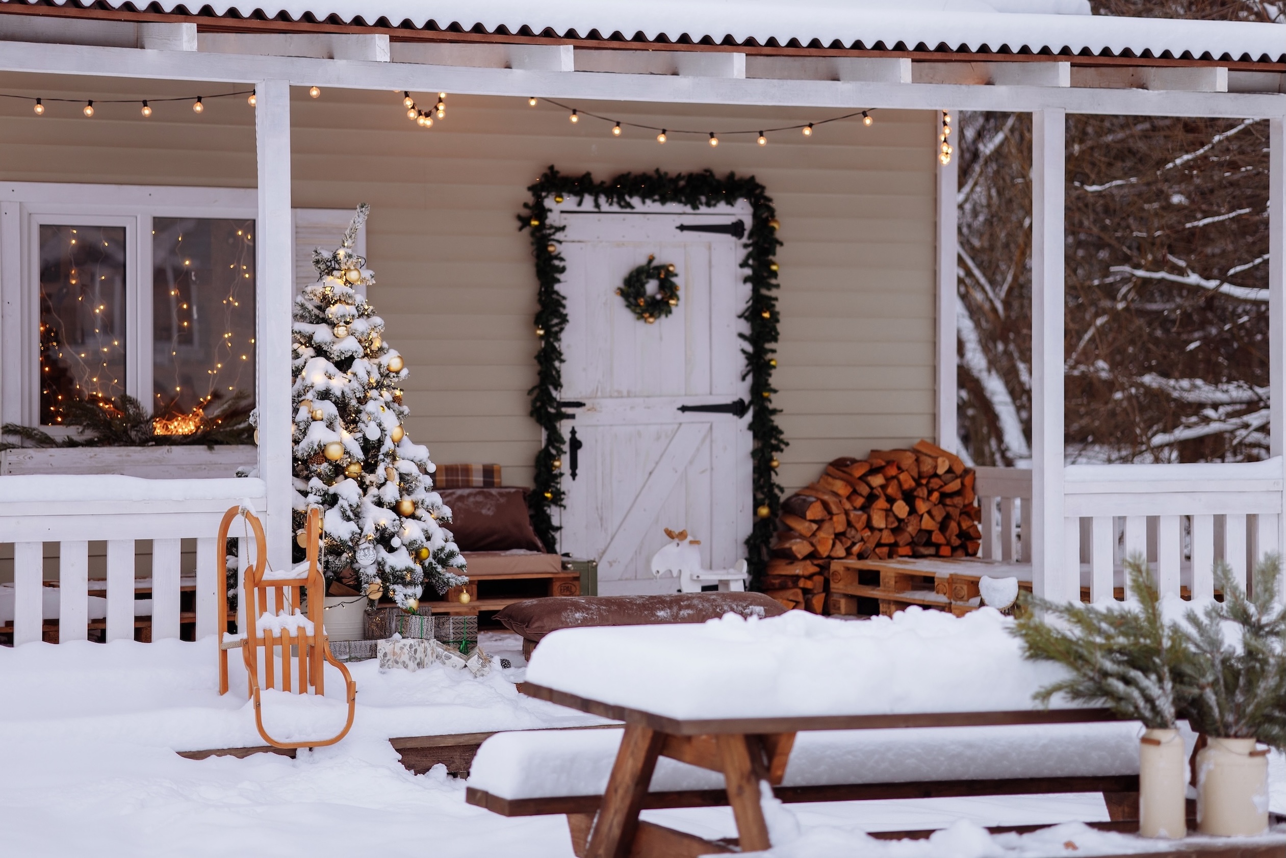 Snowy front porch with lights on a winter day