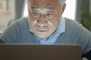 Senior man using a laptop.
