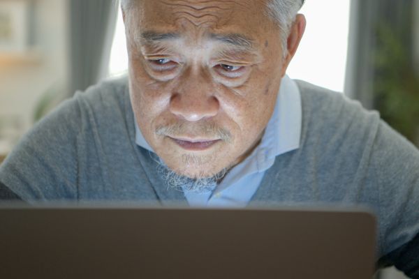Senior man using a laptop.