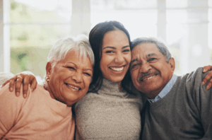 An elderly caregiver daughter with her senior parents.
