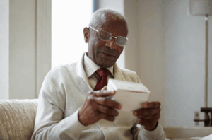 Senior man examining a box.