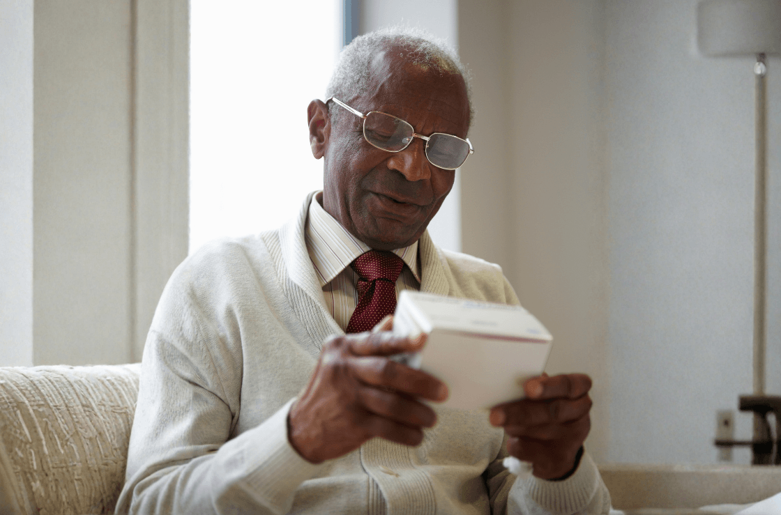 Senior man examining a box.