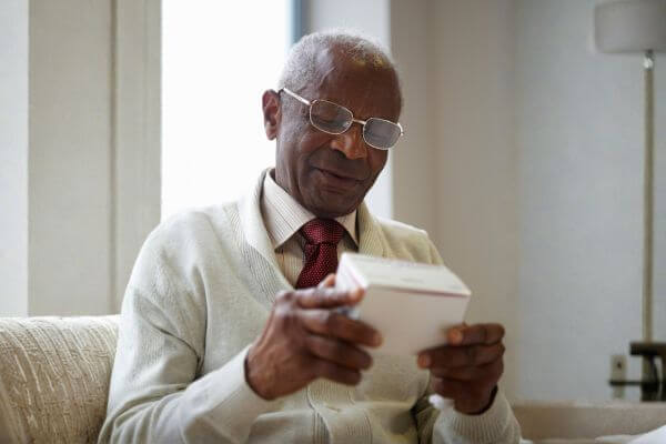 Senior man examining a box.