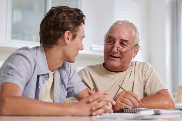An older man and his son having a discussion.