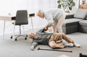A woman assists a man who has fallen