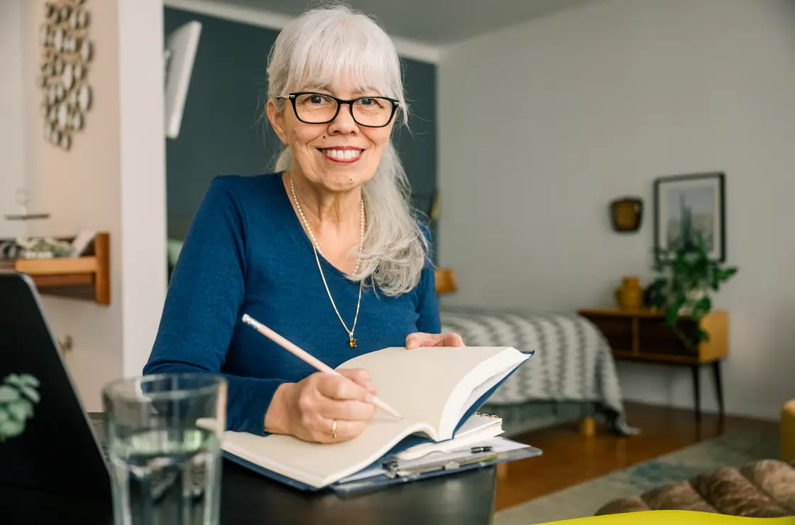 elderly women notebooking inside her home