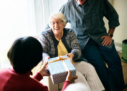 A woman receives a gift.