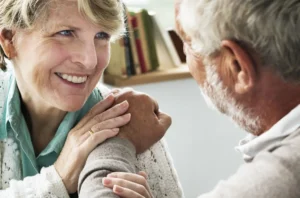 elderly couple helping each other through love
