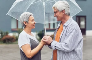 couple talking under the rain with umbrella