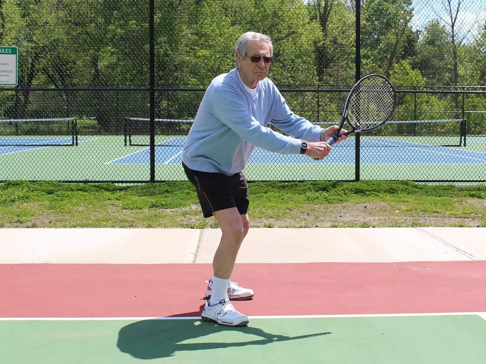 Elderly man playing tennis wearing the Kenga Watch