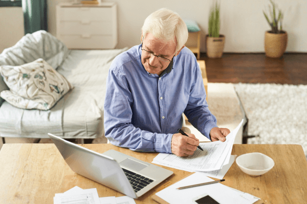 A man filling out paperwork.