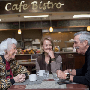 Three seniors enjoying coffee together while wearing Kanega Watches